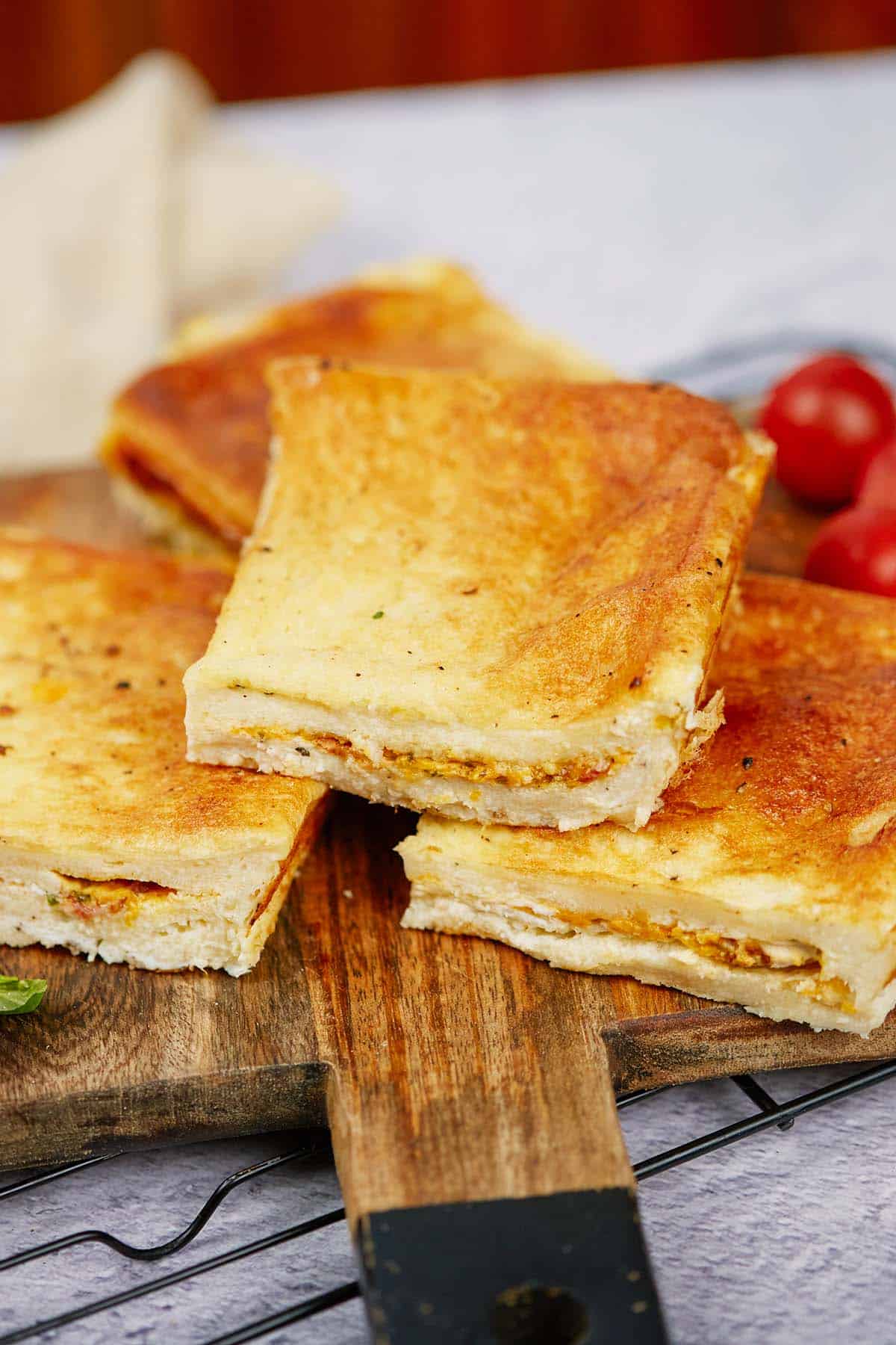 three pieces of bacon grilled cheese sandwich casserole on a table to serve