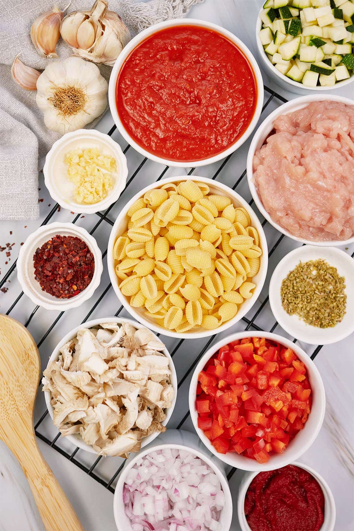 overhead view of the ingredients to make baked cavatelli casserole laid out on a table