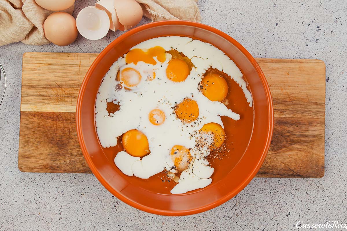 adding eggs and cream into a bowl to make baked denver omelette