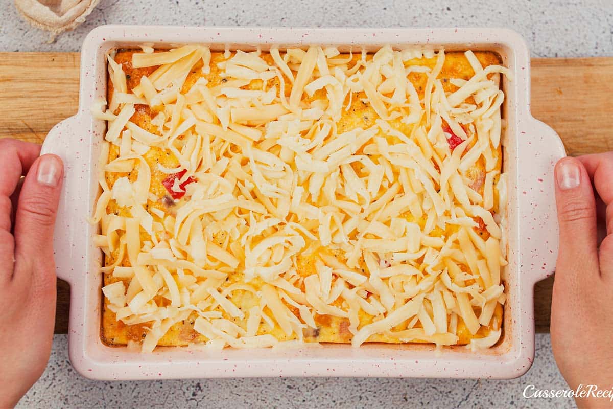 final step of making baked denver omelette by topping it with cheese prior to baking