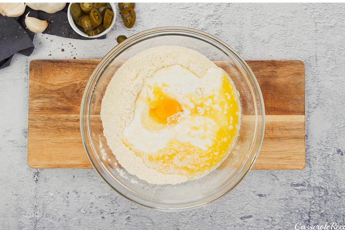 eggs and other ingredients being mixed in a bowl to make bbq chicken pot pie