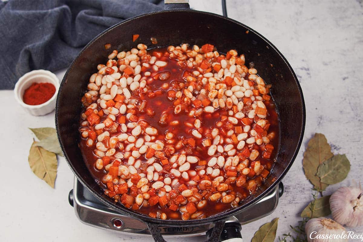 adding tomato sauce to other ingredients to make best ever sausage casserole