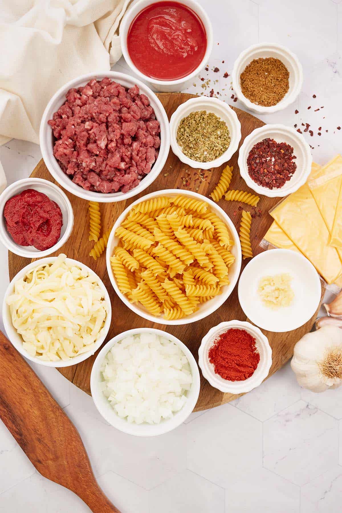 ingredients to make cheeseburger casserole laid out on a table