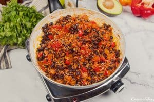 combining ingredients in a pan to make chipotle black bean dump and bake casserole