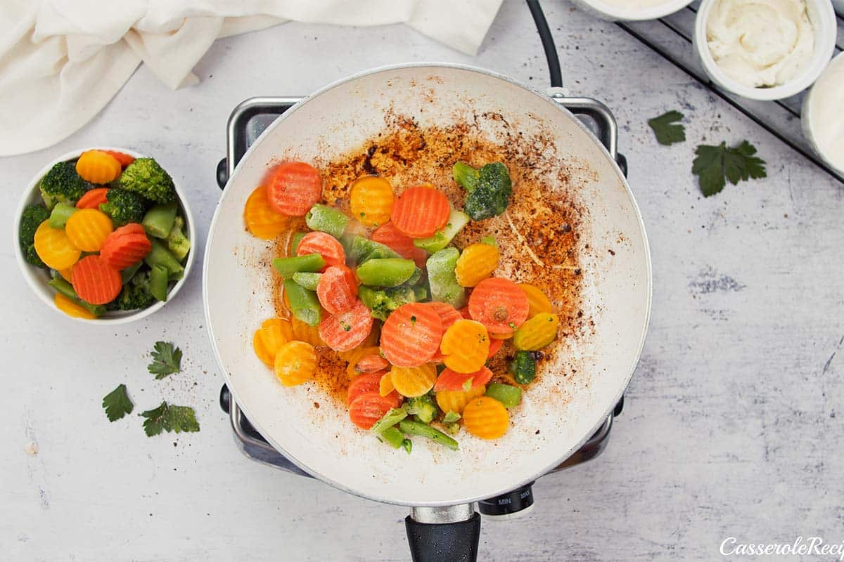 cooking vegetables in preparation to make creamy meatball casserole