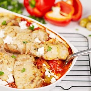 fork lifting a serving of greek chicken bake from a casserole dish