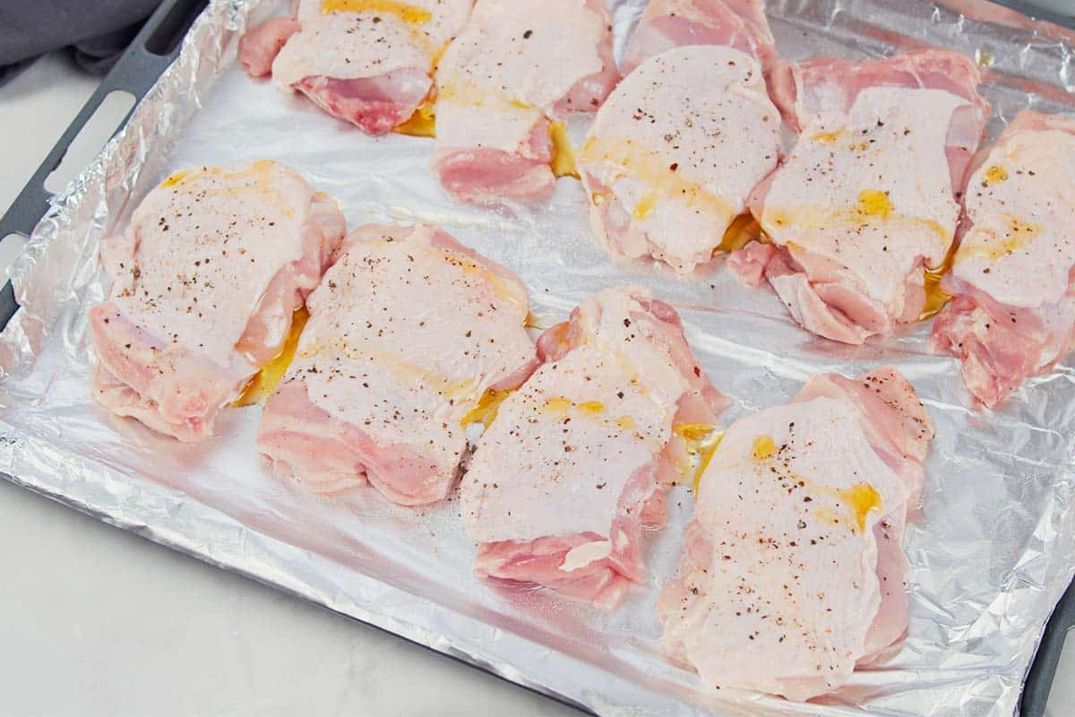 chicken being seasoned prior to baking to make hot chicken salad bake