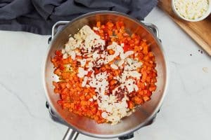 sauteeing ingredients to make hot chicken salad bake