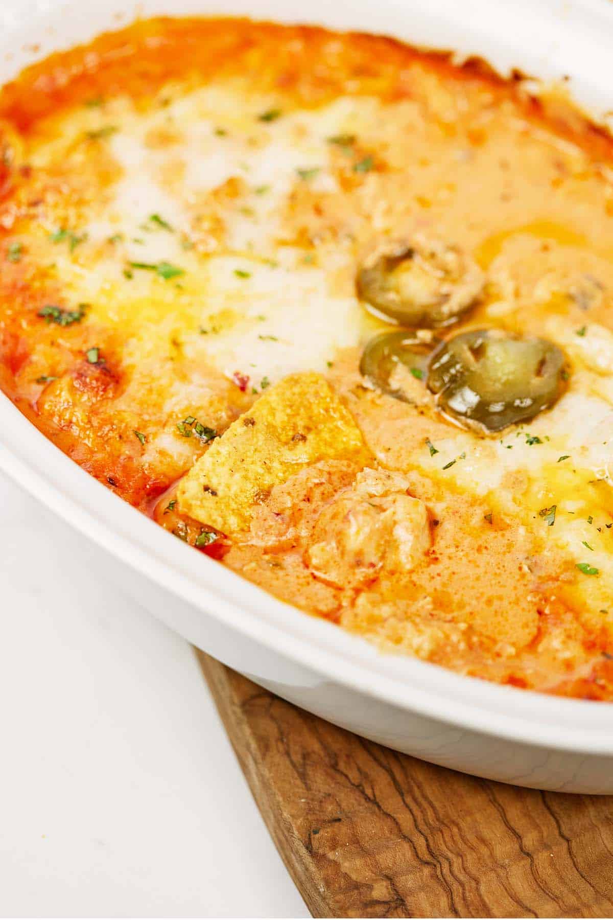 baking dish of hot sausage dip on a table fresh from the oven