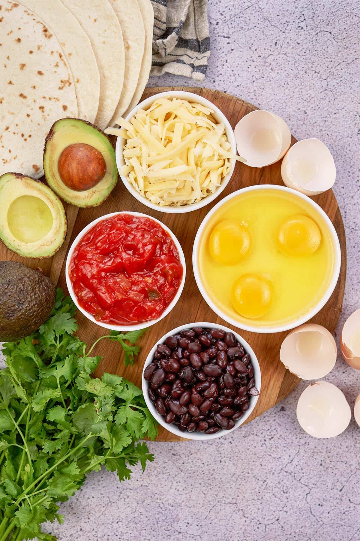ingredients to make huevos rancheros casserole laid out on a table