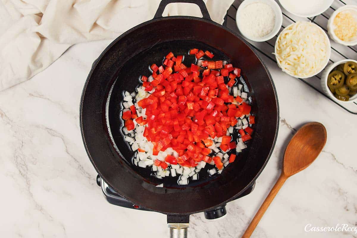 onions and other ingredients being sauteed to make king ranch chicken casserole