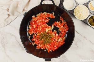 jalapenos and other ingredients being sauteed to make king ranch chicken casserole