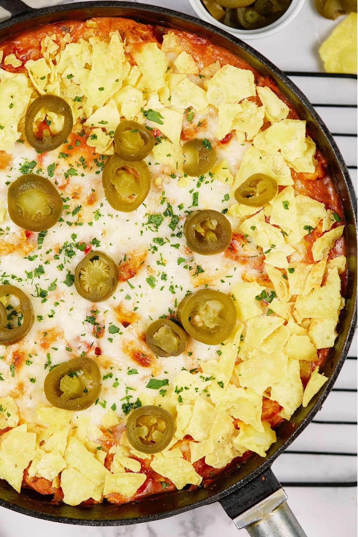 closeup of king ranch chicken casserole in a cast iron skillet