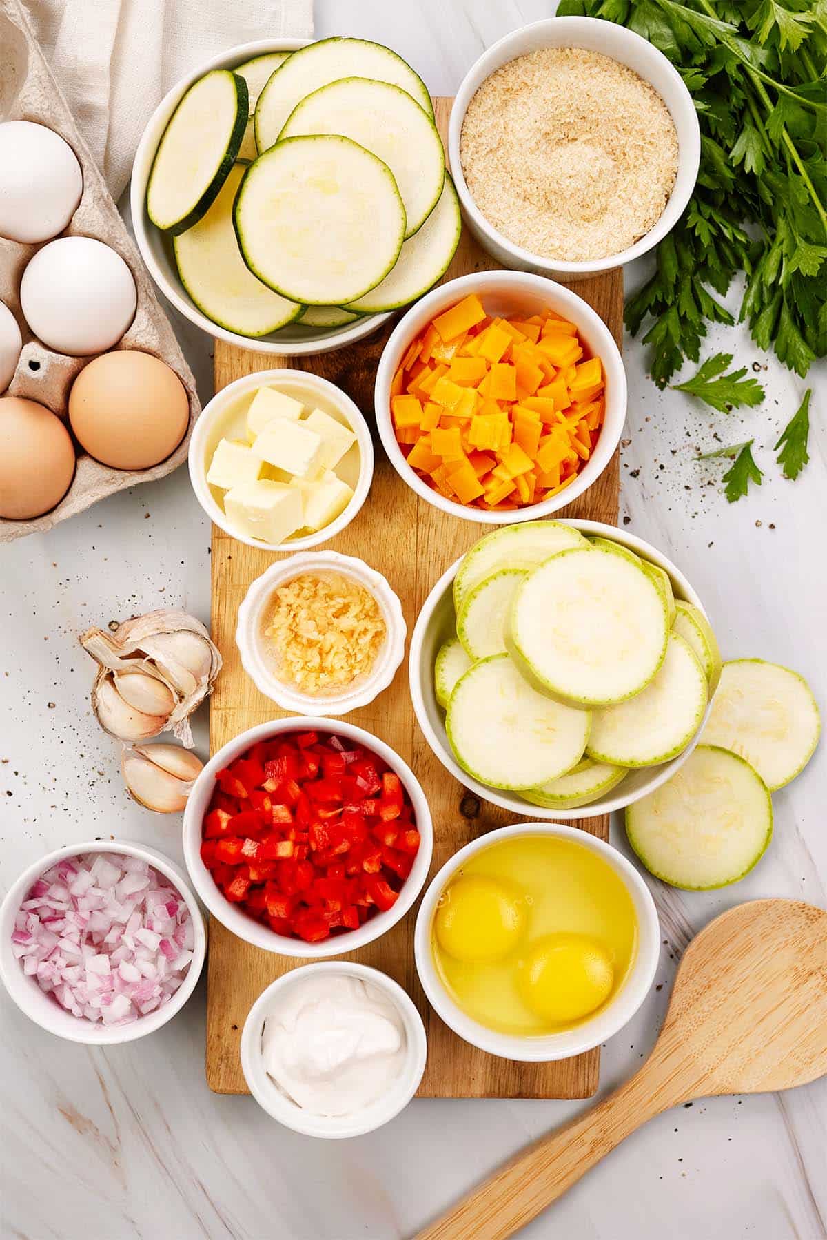 ingredients to make mini squash casserole laid out on a table
