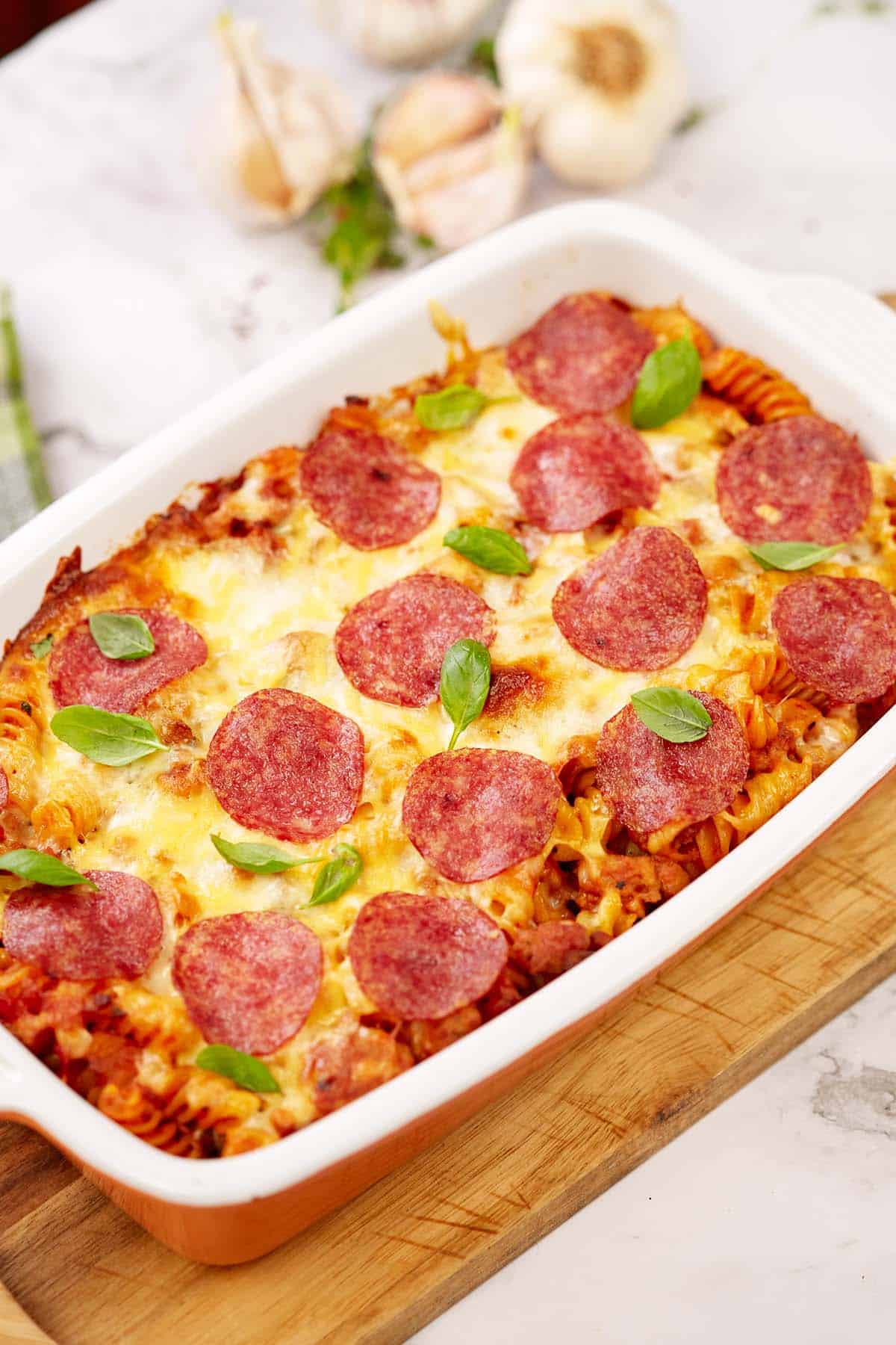 noodle pizza casserole in a baking dish just finished cooking and pulled out of the oven to serve
