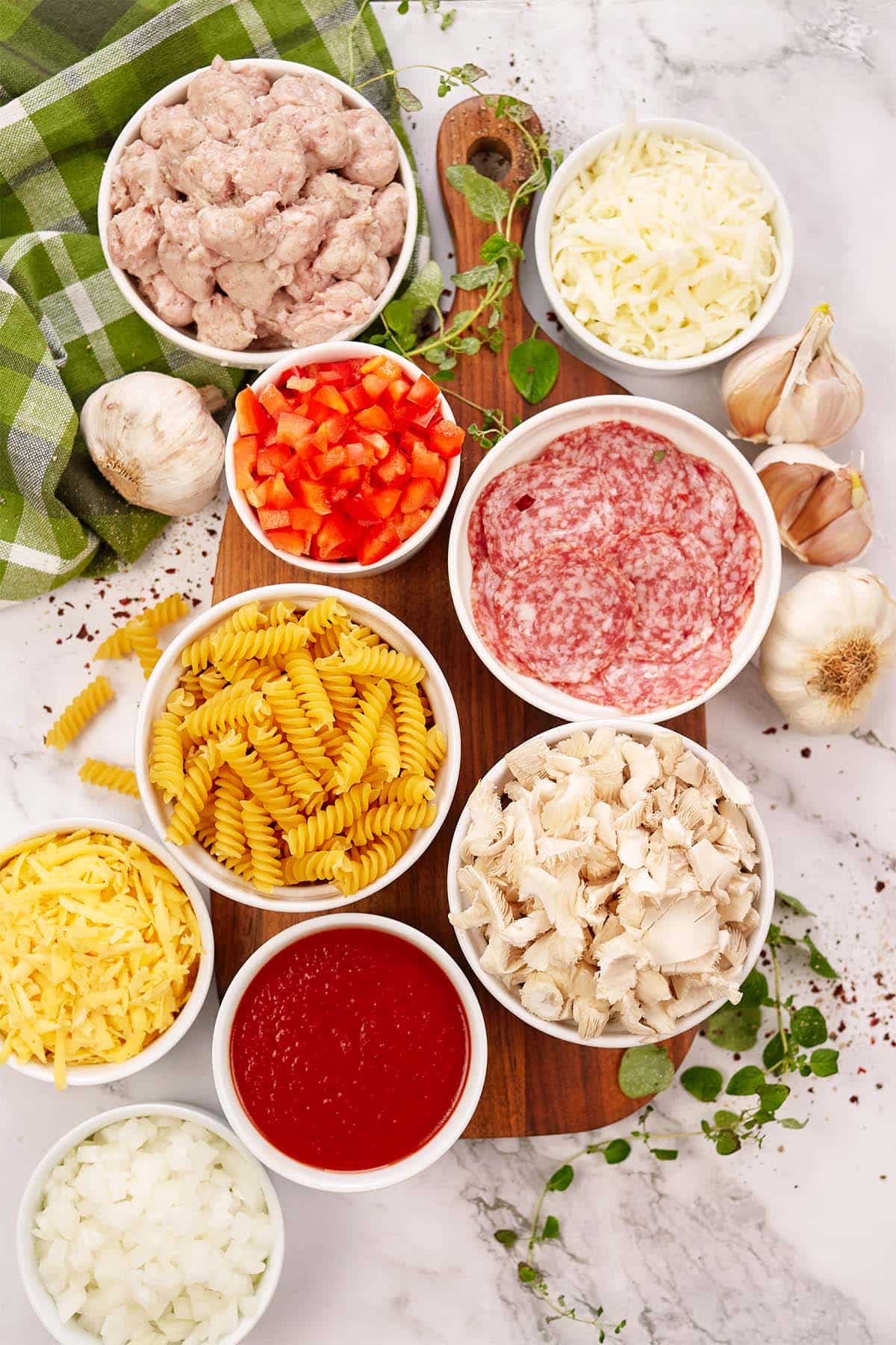 ingredients to make noodle pizza casserole laid out on a table