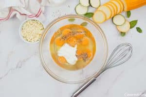 eggs and other ingredients in a bowl to make oven-baked zucchini fritatta