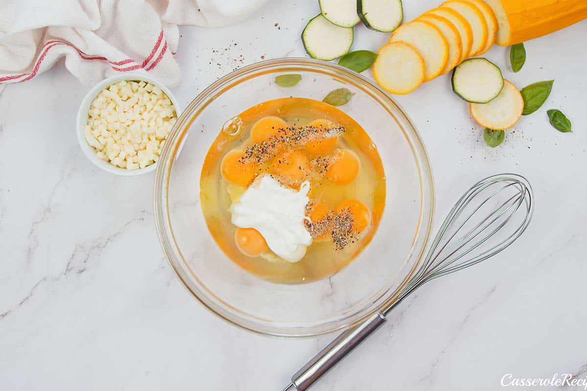 eggs and other ingredients in a bowl to make oven-baked zucchini fritatta