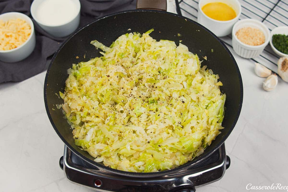 cabbage being sauteed to make polish cabbage, potato and bacon casserole