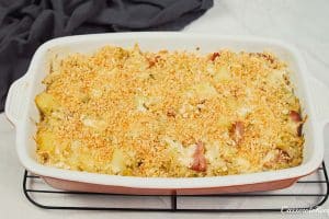 final step of topping the polish cabbage, potato and bacon casserole with crushed crackers before baking for the final time