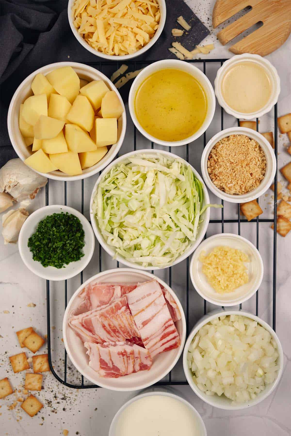 ingredients laid out on a table to make polish cabbage, potato and bacon casserole