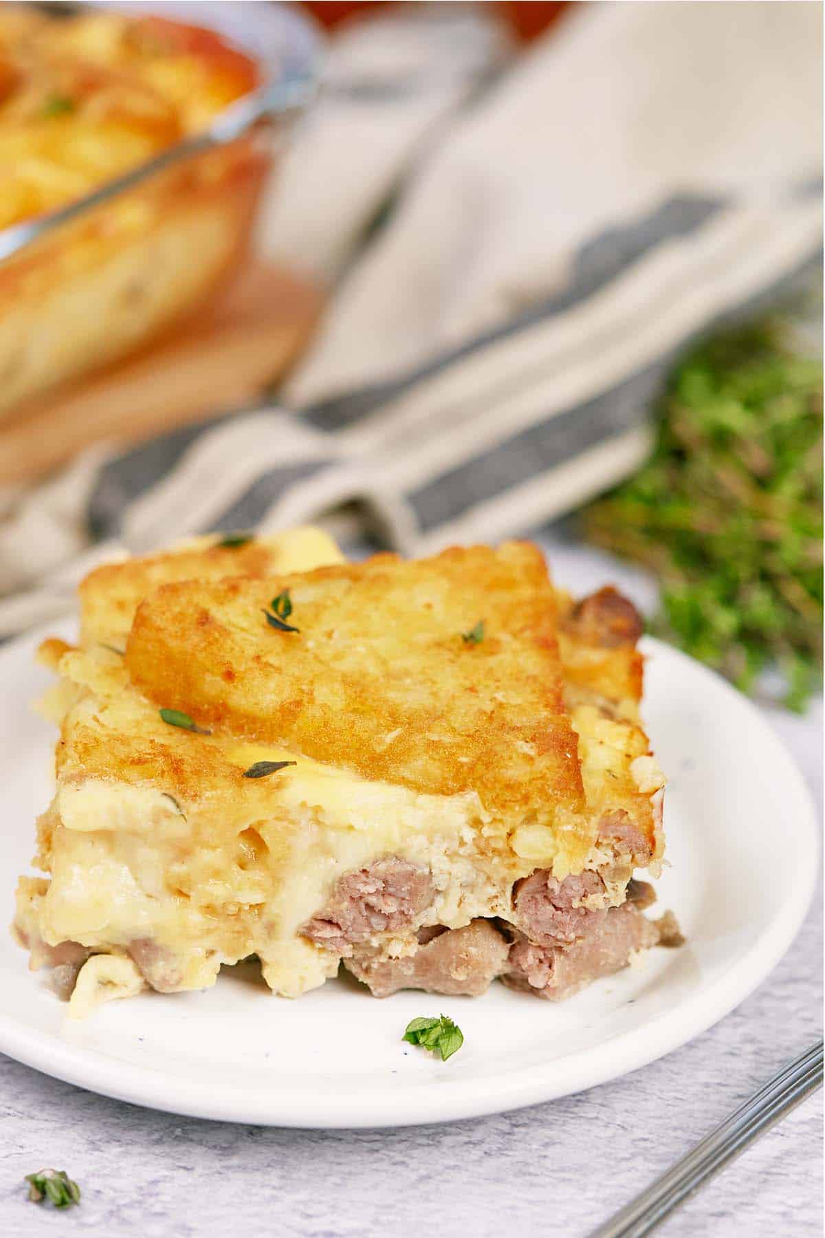 serving of sausage hashbrown breakfast casserole on a plate ready to enjoy