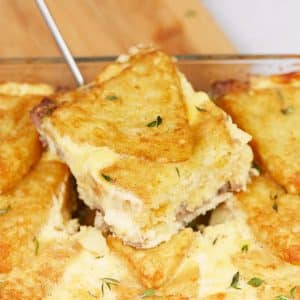 spatula lifting a serving of sausage hashbrown breakfast casserole from a baking dish
