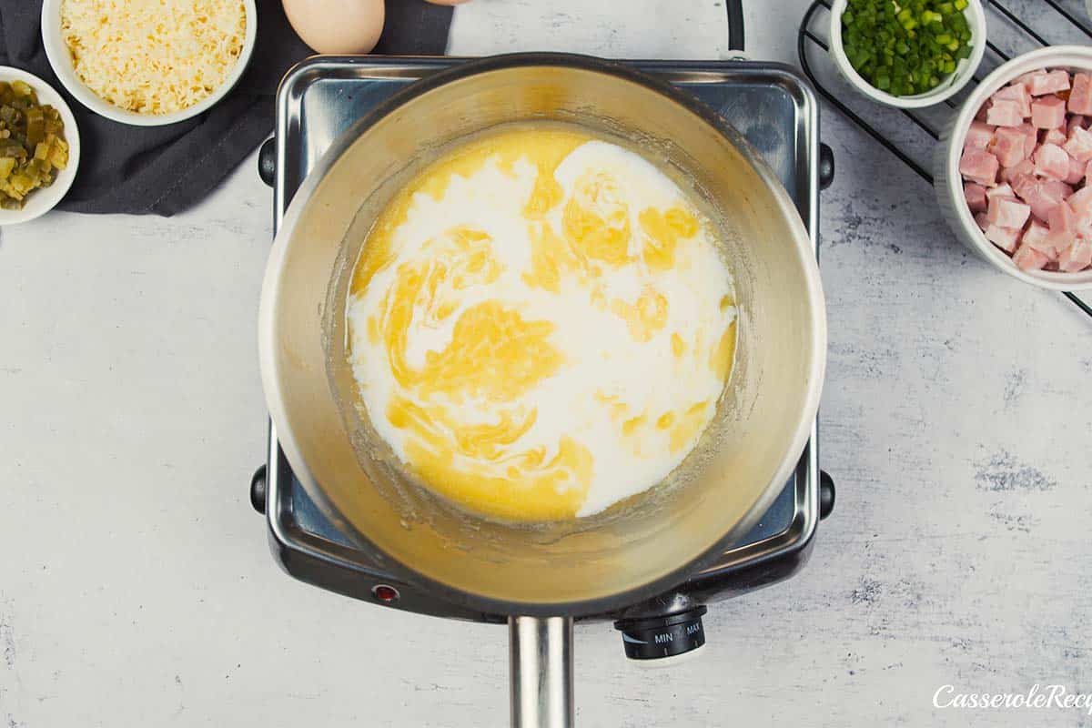 ingredients being cooked together in a sauce pan to make scrambled egg casserole