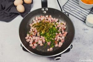 ingredients being sauteed together in a pan to make scrambled egg casserole