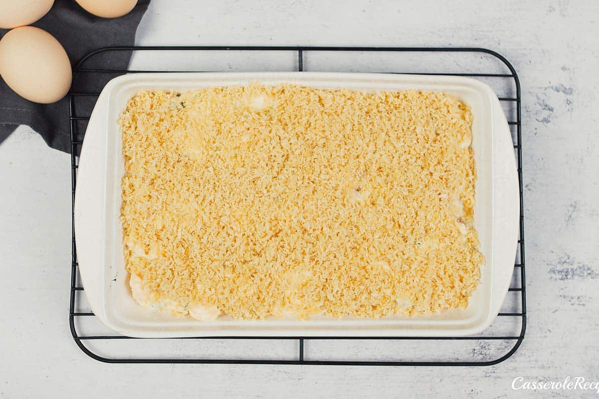 final step of adding breadcrumbs to the top of the casserole to make scrambled egg casserole