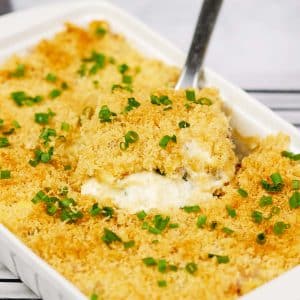 spatula lifting a serving of scrambled egg casserole from a baking dish