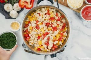 sauteeing ingredients to make stuffed pepper casserole
