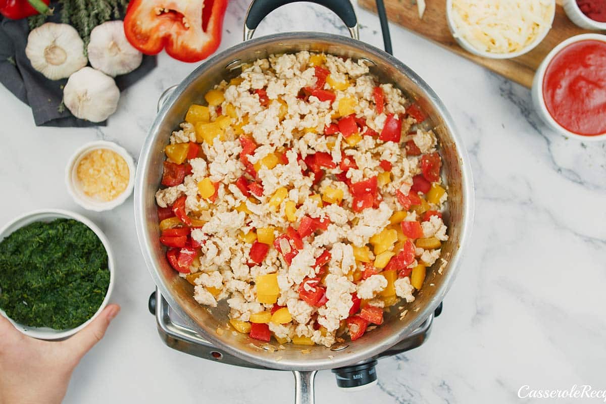 sauteeing ingredients to make stuffed pepper casserole