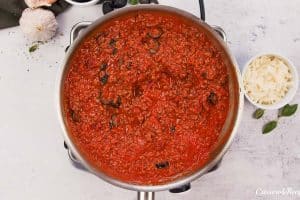 cooking ingredients together in a saucepan to make upside down pizza casserole