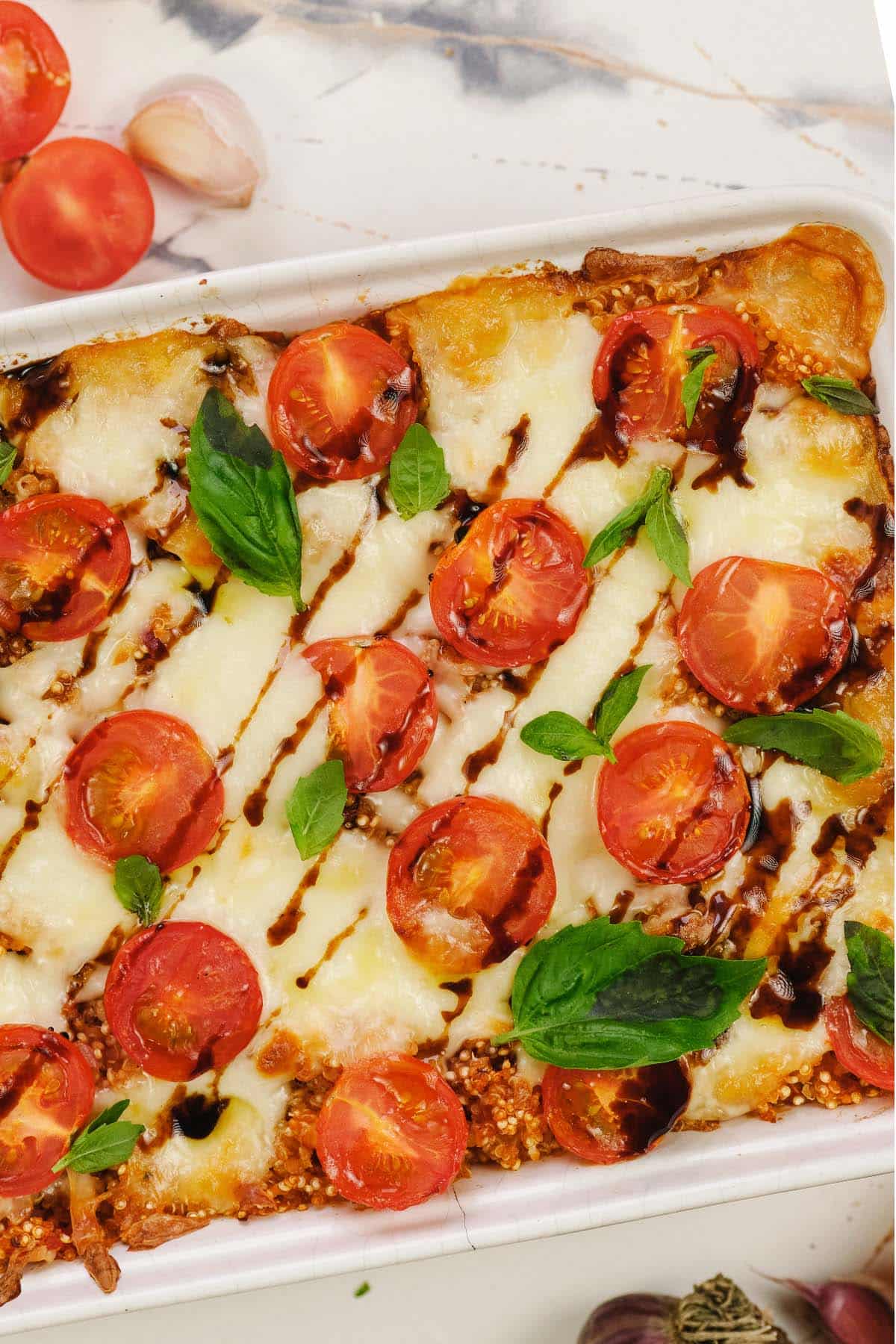 overhead view of baking dish of Caprese Quinoa Bake ready to serve