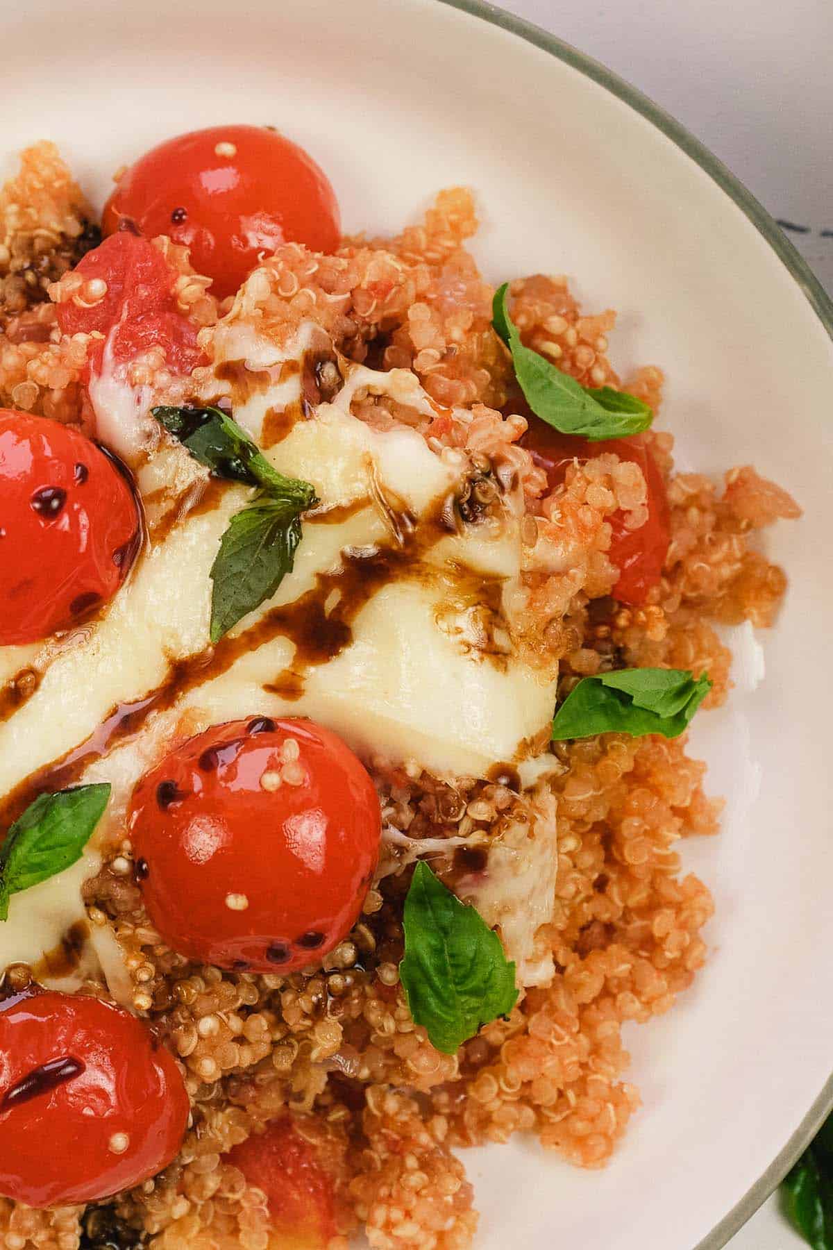 closeup of a plate containing a serving of Caprese Quinoa Bake ready to enjoy