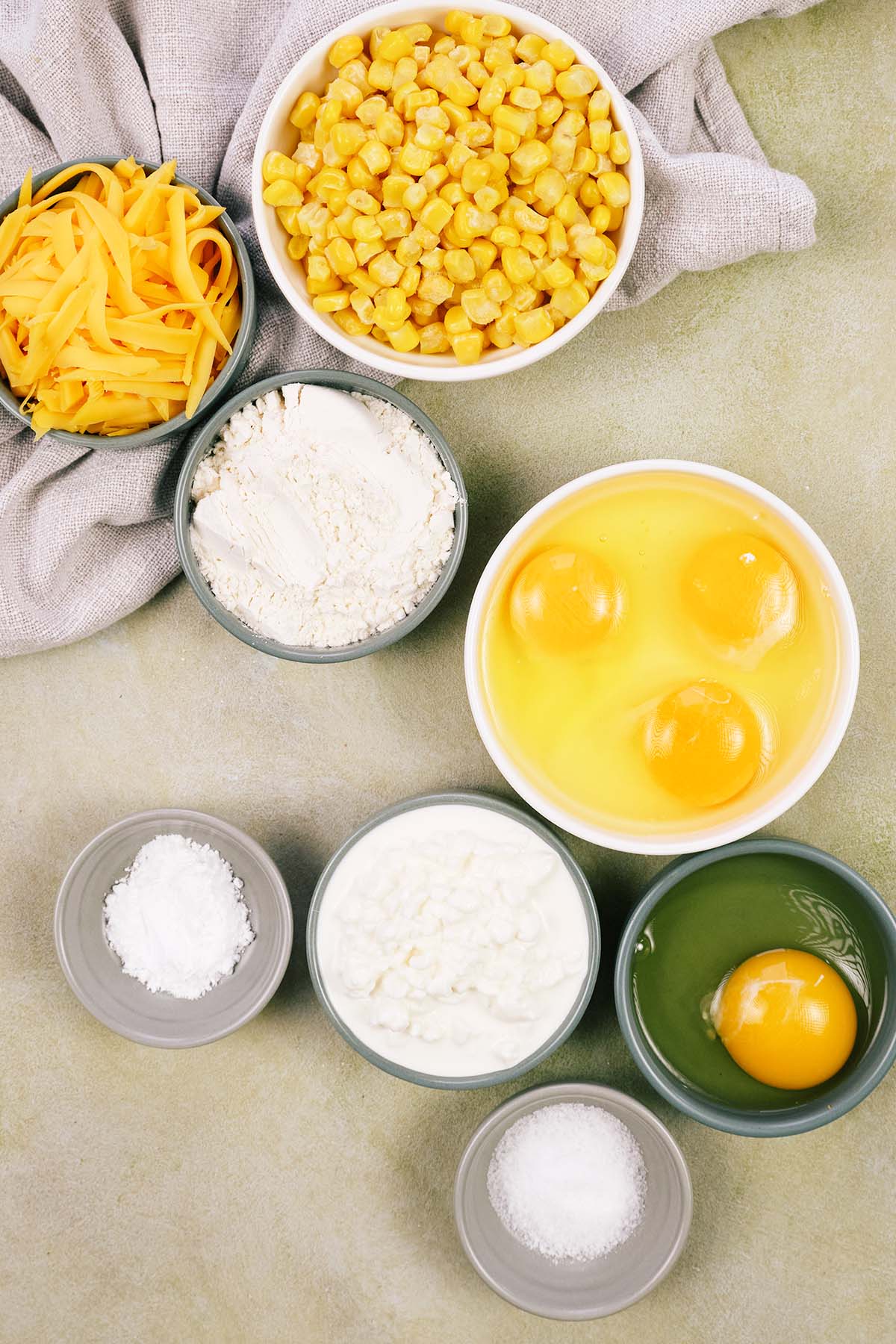 ingredients to make Corn and Cheese Pashtida Crustless Corn Quiche laid out on a table