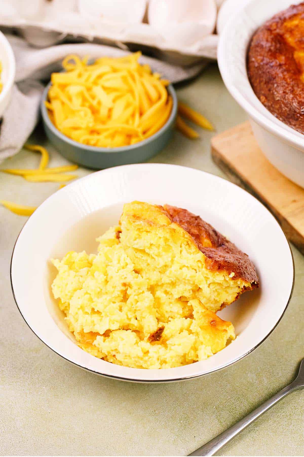 bowl with a serving of Corn and Cheese Pashtida Crustless Corn Quiche on a table