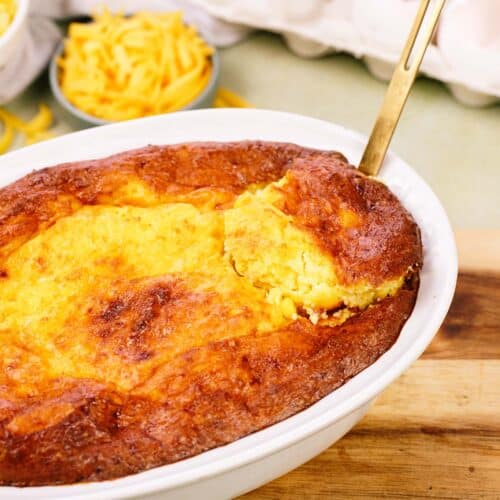 serving of Corn and Cheese Pashtida Crustless Corn Quiche being lifted from a baking dish