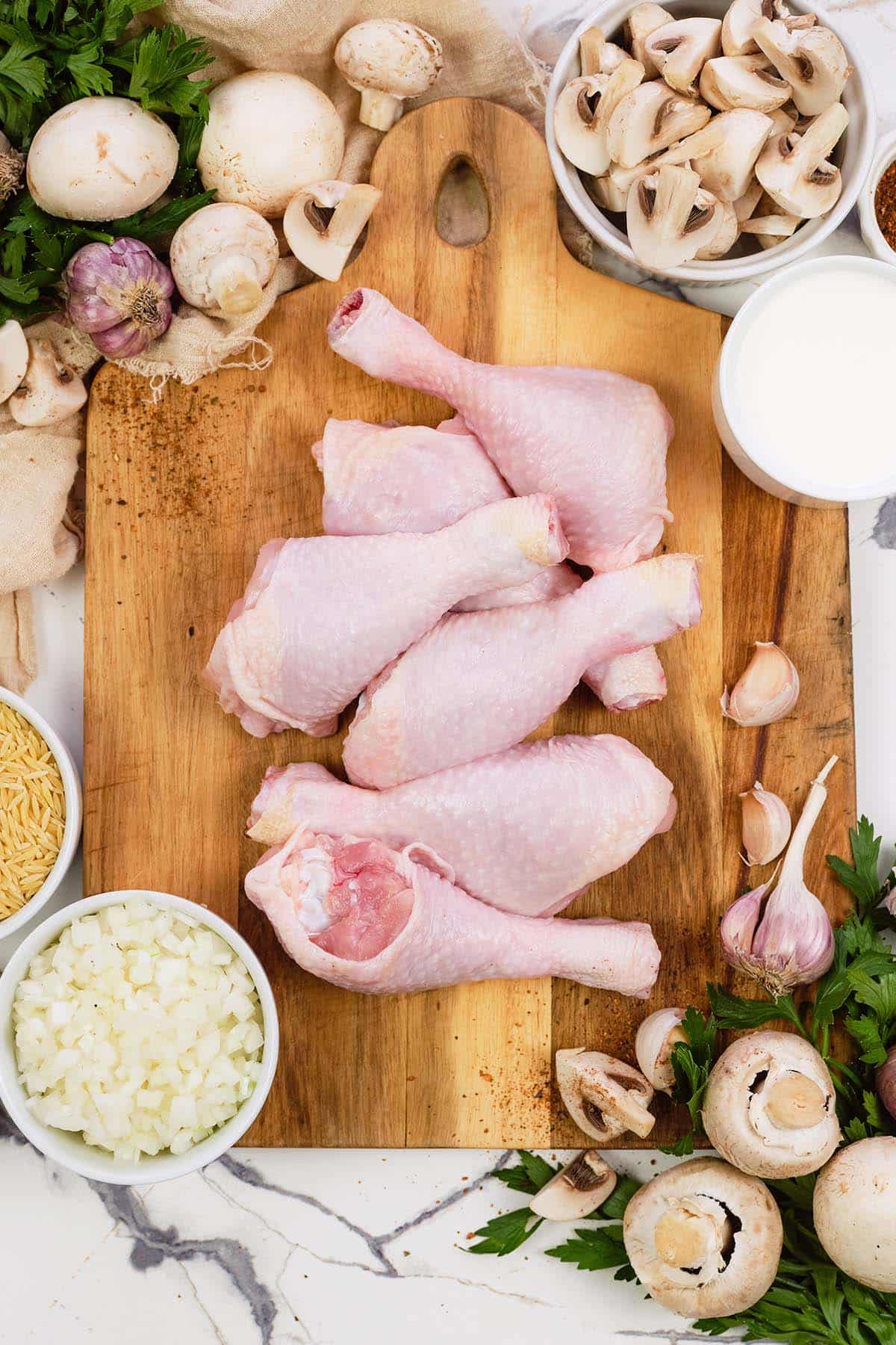 ingredients to make Creamy Orzo Chicken Bake laid out on a table