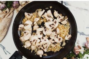 mushrooms and other ingredients being sauted to make Creamy Orzo Chicken Bake