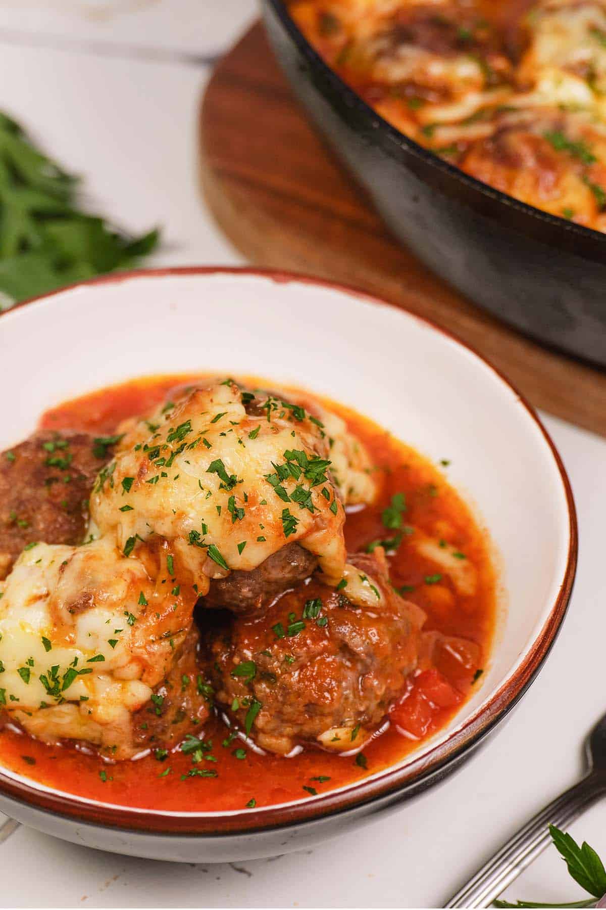 bowl containing a serving of Sloppy Joe Meatball Bake on a table ready to enjoy