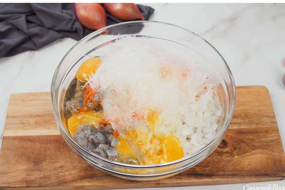 ingredients being combined in a bowl to make Vietnamese Pork Bake
