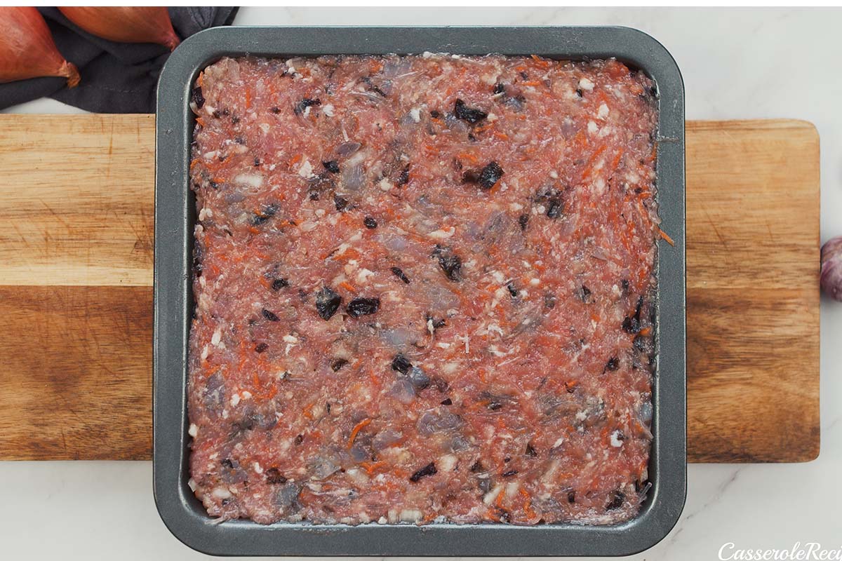 placing filing for Vietnamese Pork Bake in a baking dish prior to baking