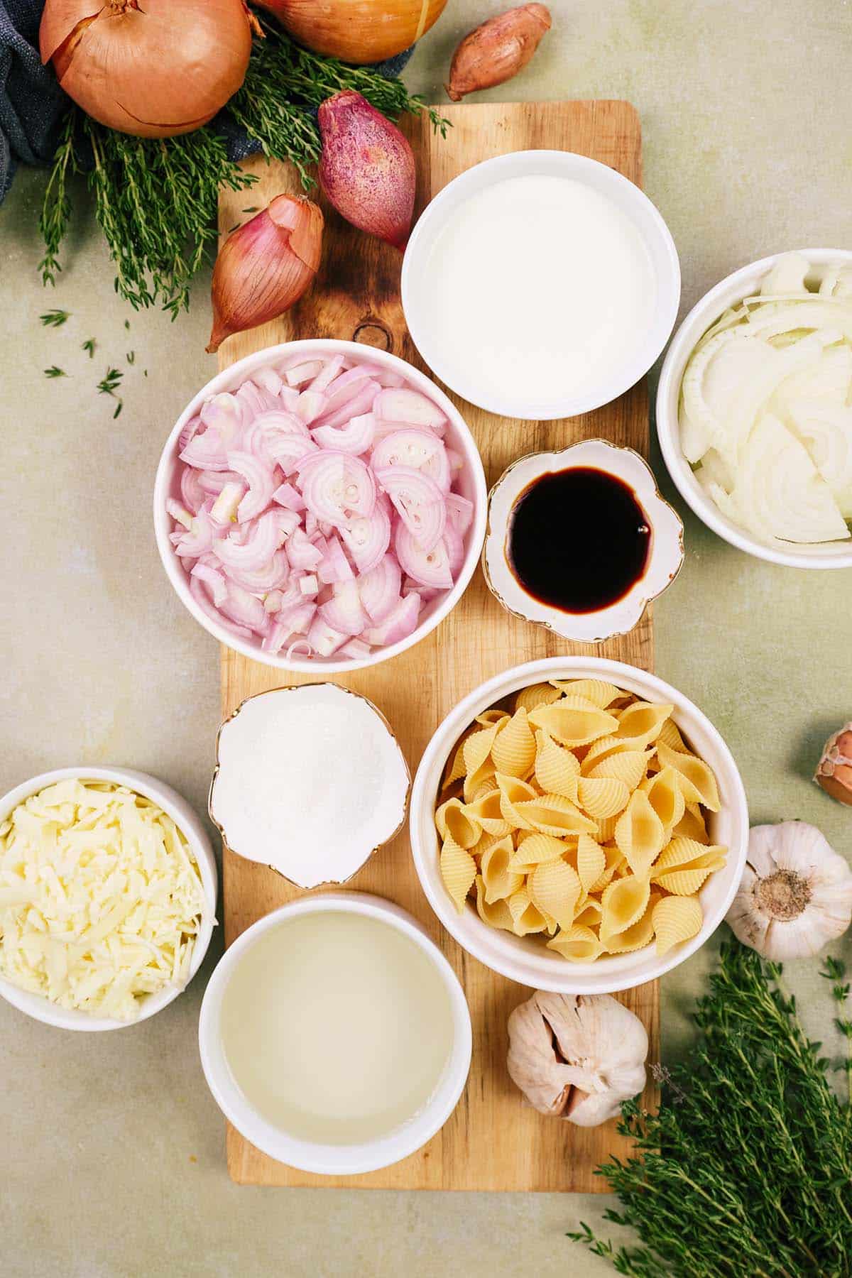 ingredients to make caramelized onion pasta bake laid out on a table