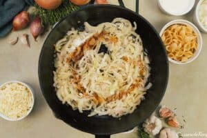 onions and seasonings being sauteed together to make caramelized onion pasta bake