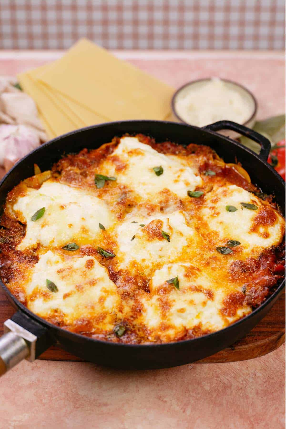 cast iron skillet of cheat lasagne bake fresh from the oven