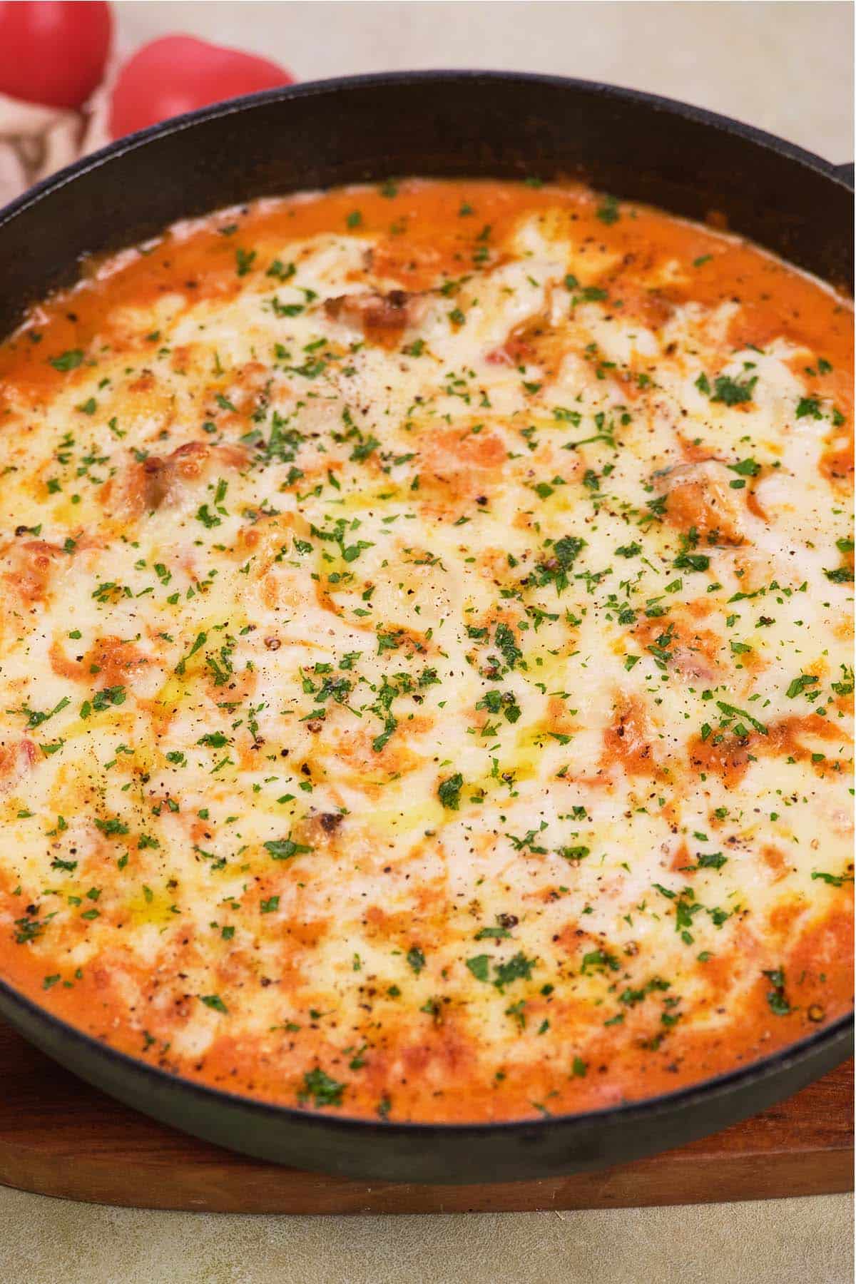 chicken and tomato gnocchi bake in a cast iron skillet ready to serve