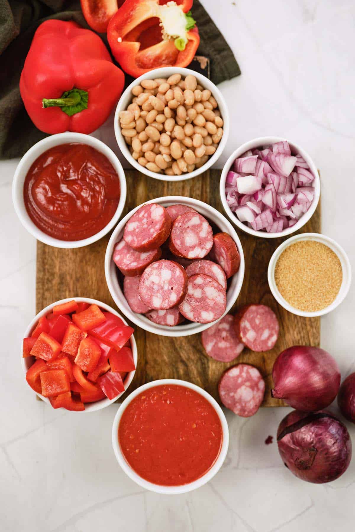 ingredients to make kielbasa bake laid out on a table
