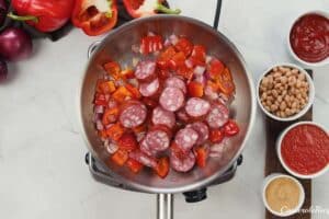 combination of sausage and other ingredients in a frying pan to make kielbasa bake